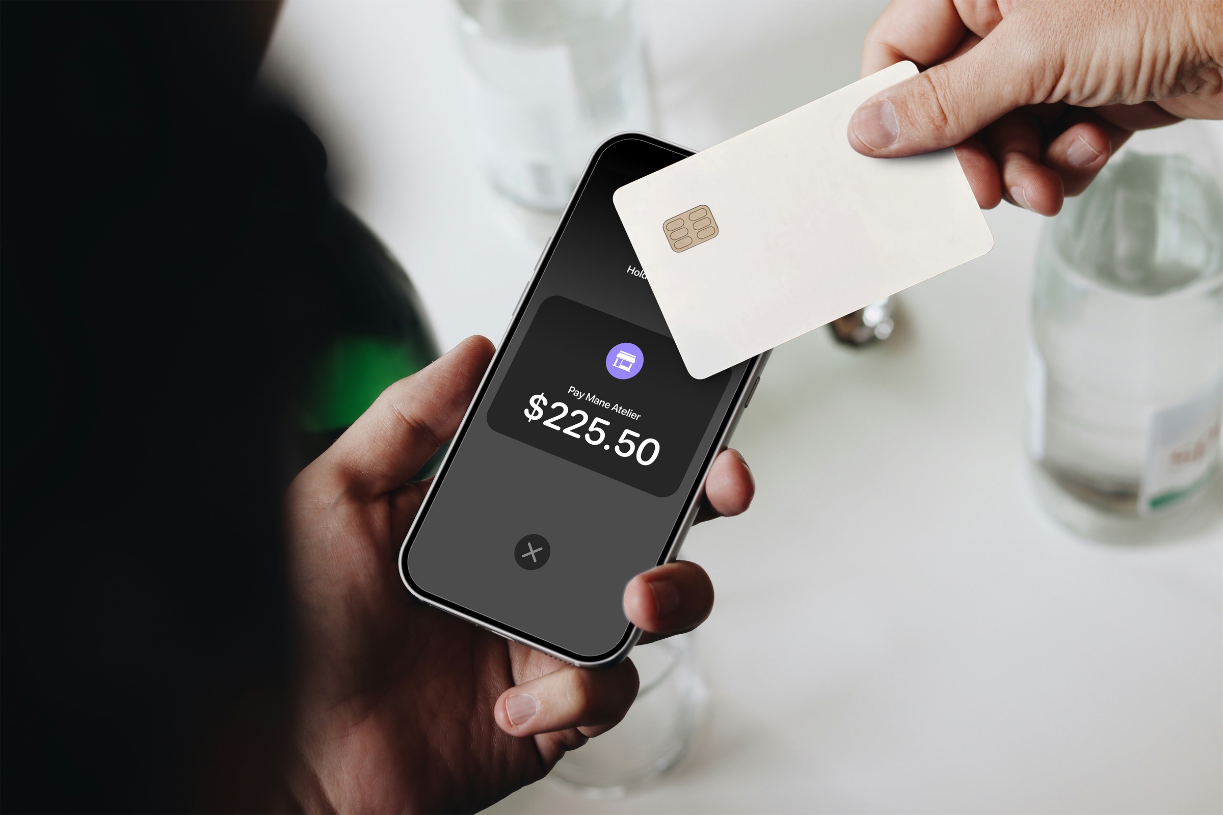 Hands taking a card payment with GlossGenius
