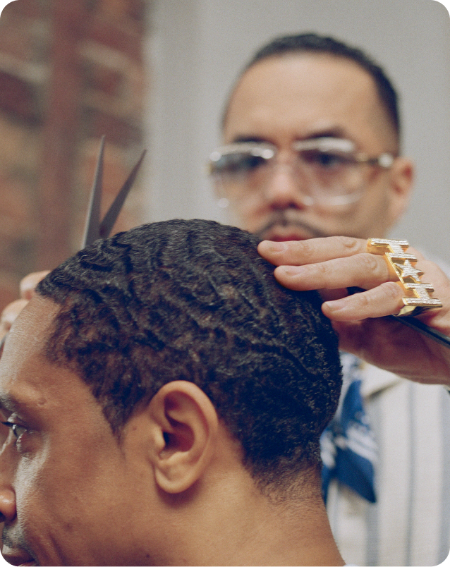 Barber cutting hair with precision styling