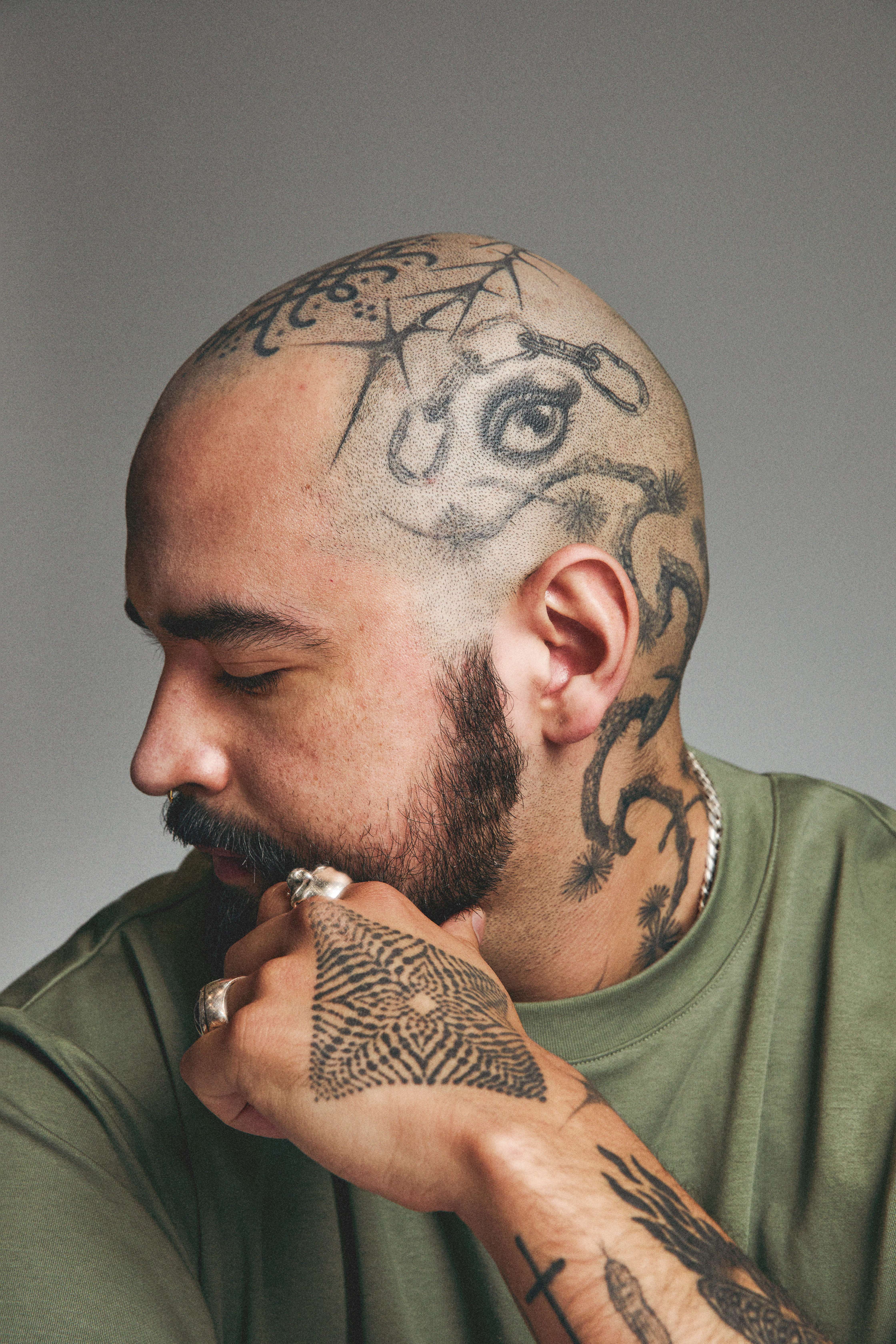 Portrait of tattooed man in thoughtful pose